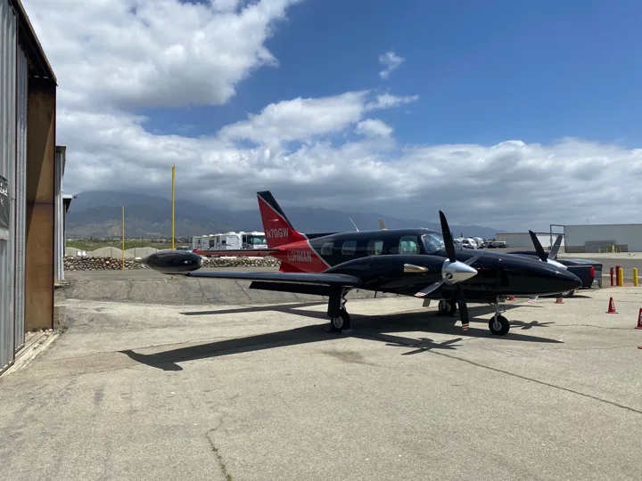 Opposite front quarter view of the dark twin-engine paint scheme