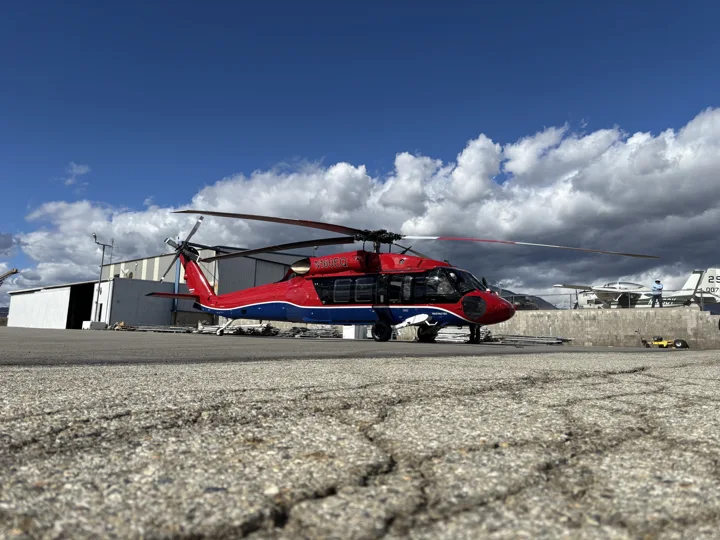 Red and black helicopter on the airport ramp