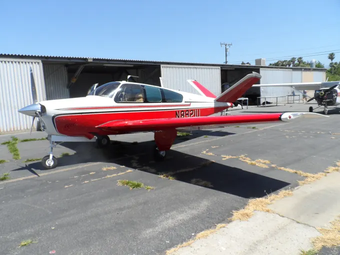 Red-and-white low-wing aircraft